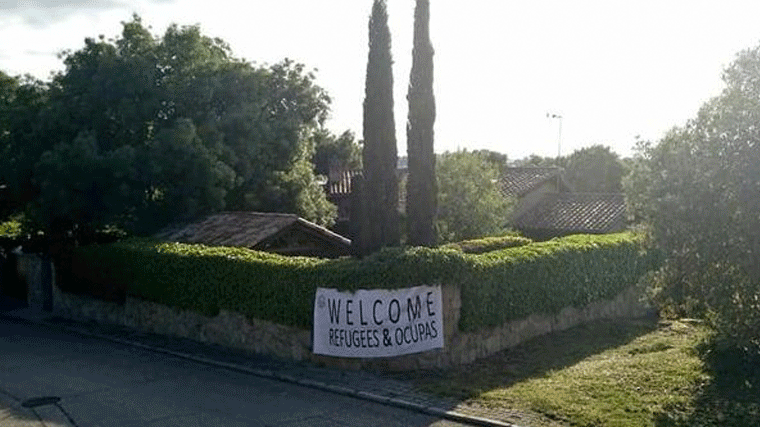 Pancarta de Vox en el chalé de Iglesias y Monterio; 'Welcome Refugees & Ocupas'